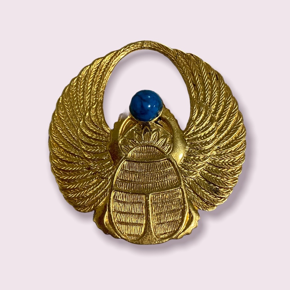 Egyptian gold tone pendant with a turquoise stone